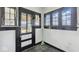 Mud room with black and white trim, large windows, and tile flooring at 21 N Bosart Ave, Indianapolis, IN 46201