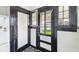 Mud room with vintage door, window and tile flooring at 21 N Bosart Ave, Indianapolis, IN 46201