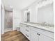 Bathroom with granite countertops, double sinks, white cabinets and a glass shower at 2327 Mimosa Ln, Anderson, IN 46011