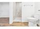 Toilet, walk in shower and entrance to walk in closet, complete with wood-look floors at 2327 Mimosa Ln, Anderson, IN 46011