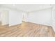 A bright, empty room with hardwood floors and a door to the bathroom at 2327 Mimosa Ln, Anderson, IN 46011