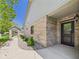 Brick exterior with a covered entryway and black front door framed by green landscaping at 2327 Mimosa Ln, Anderson, IN 46011
