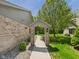 Brick house with a covered walkway and manicured landscaping leading to the main house at 2327 Mimosa Ln, Anderson, IN 46011
