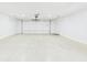 Spacious and clean garage featuring a white garage door and concrete floor at 2327 Mimosa Ln, Anderson, IN 46011