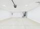 Bright garage with a white door, furnace, and plenty of space for parking and storage at 2327 Mimosa Ln, Anderson, IN 46011