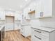 Bright kitchen with white cabinets, granite countertops, and wood flooring at 2327 Mimosa Ln, Anderson, IN 46011