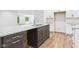 Granite countertop kitchen island with dark wood finish, stainless steel sink, and light cabinets at 2327 Mimosa Ln, Anderson, IN 46011