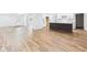 Bright kitchen featuring an island, sleek white cabinetry, and wood-look flooring at 2327 Mimosa Ln, Anderson, IN 46011