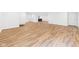 Spacious room with wood flooring, white walls, and multiple doorways for versatile use at 2327 Mimosa Ln, Anderson, IN 46011