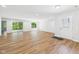Spacious living room featuring wood floors, bright lighting and a sliding glass door to the back at 2327 Mimosa Ln, Anderson, IN 46011