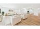 Bright living room with stylish white furniture, wood floors, and an open floor plan at 2327 Mimosa Ln, Anderson, IN 46011