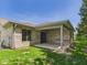 Exterior view of a brick home with a covered patio and green lawn at 2327 Mimosa Ln, Anderson, IN 46011