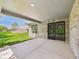 Covered patio with brick pillars, screened doors, and concrete flooring, perfect for outdoor living at 2327 Mimosa Ln, Anderson, IN 46011