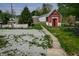 View of backyard featuring weathered shed, gravel area, and sidewalk at 2402 N B St, Elwood, IN 46036