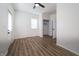 Bright bedroom with light walls, modern flooring, a ceiling fan, and a closet for serene comfort at 2402 N B St, Elwood, IN 46036