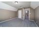 Bright bedroom features plush carpet, neutral walls, white trim, and adjacent room at 2402 N B St, Elwood, IN 46036
