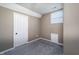 Cozy bedroom featuring plush carpet, neutral walls, and a bright window at 2402 N B St, Elwood, IN 46036