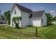 Charming white home with neatly kept yard and wrought iron fence at 2402 N B St, Elwood, IN 46036
