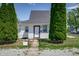 Inviting home with tidy yard and ornamental shrubs and decorative wrought iron fence at 2402 N B St, Elwood, IN 46036