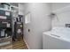 Functional laundry area with appliances and shelving, providing convenience and organized space for household chores at 2402 N B St, Elwood, IN 46036