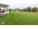 Large, well-maintained backyard with a covered patio area, perfect for outdoor relaxation at 2432 Scarlet Oak Dr, Avon, IN 46123