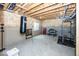 Unfinished basement with exposed wooden beams, concrete floors, and gym equipment at 2432 Scarlet Oak Dr, Avon, IN 46123