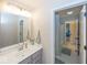 Bright bathroom featuring a single vanity with a light grey cabinet and a large mirror at 2432 Scarlet Oak Dr, Avon, IN 46123