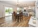 Open dining area with a table and chairs, leading to a modern kitchen and sliding door access at 2432 Scarlet Oak Dr, Avon, IN 46123