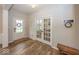 Inviting foyer with white trim and hardwood floors, featuring a front door and french doors at 2432 Scarlet Oak Dr, Avon, IN 46123
