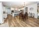 Open-concept kitchen featuring an island with seating, stainless appliances, and a dining area at 2432 Scarlet Oak Dr, Avon, IN 46123