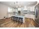Bright kitchen features a center island with seating, white cabinets, and modern appliances at 2432 Scarlet Oak Dr, Avon, IN 46123
