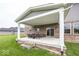 Covered back patio with brick construction and comfortable outdoor seating at 2432 Scarlet Oak Dr, Avon, IN 46123