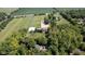 A captivating aerial view highlighting the home's location, horse facilities, and serene landscape at 2450 S Us 421, Zionsville, IN 46077