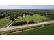 Aerial of well-maintained horse farm with paddocks, riding area, and lush green fields at 2450 S Us 421, Zionsville, IN 46077