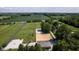 Aerial view of horse property featuring green pastures and outdoor riding arena at 2450 S Us 421, Zionsville, IN 46077
