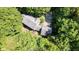 Aerial view of charming home nestled in a lush forest with mature trees and a gray roof at 2450 S Us 421, Zionsville, IN 46077