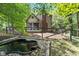 Beautiful backyard features a decorative pond and a fenced-in area with mature trees at 2450 S Us 421, Zionsville, IN 46077