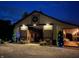 Exterior night view of horse barn with an open patio and seating at 2450 S Us 421, Zionsville, IN 46077