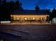 Exterior evening view of lit barn with an outdoor arena and seating at 2450 S Us 421, Zionsville, IN 46077