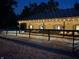 Outdoor view of a lit horse barn at night at 2450 S Us 421, Zionsville, IN 46077
