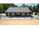 Large barn with metal roof, front porch, and gate to a riding arena at 2450 S Us 421, Zionsville, IN 46077