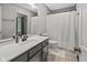 Bathroom featuring white vanity, large mirror, and shower with modern fixtures and curtain at 2450 S Us 421, Zionsville, IN 46077