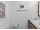Bathroom with white plank walls, modern fixtures, and a decorative equestrian print at 2450 S Us 421, Zionsville, IN 46077