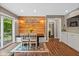 Inviting dining area featuring a wood accent wall, built-in bench seating, and sliding door access to the outside at 2450 S Us 421, Zionsville, IN 46077