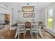 Spacious dining room with a large farmhouse table, views of the side yard, and access to multiple rooms at 2450 S Us 421, Zionsville, IN 46077
