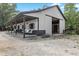 Exterior view of the barn with a porch and a large open entrance, surrounded by trees at 2450 S Us 421, Zionsville, IN 46077