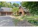 Brick two-story home featuring a front-entry two-car garage and mature trees at 2450 S Us 421, Zionsville, IN 46077