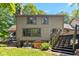 Back exterior view showcases a spacious yard, deck access, and charming architectural details at 2450 S Us 421, Zionsville, IN 46077