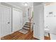 Hallway with hardwood floors leading to the stairs and a view of a bathroom at 2450 S Us 421, Zionsville, IN 46077