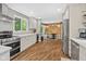 This stylish kitchen seamlessly flows into an eat-in dining area with wood accent wall at 2450 S Us 421, Zionsville, IN 46077